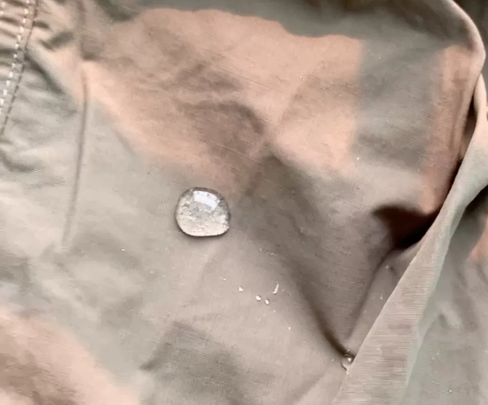 tactical raincoat for outdoor adventure in green