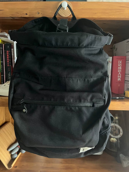 black roll-top backpack with multifunctional pockets
