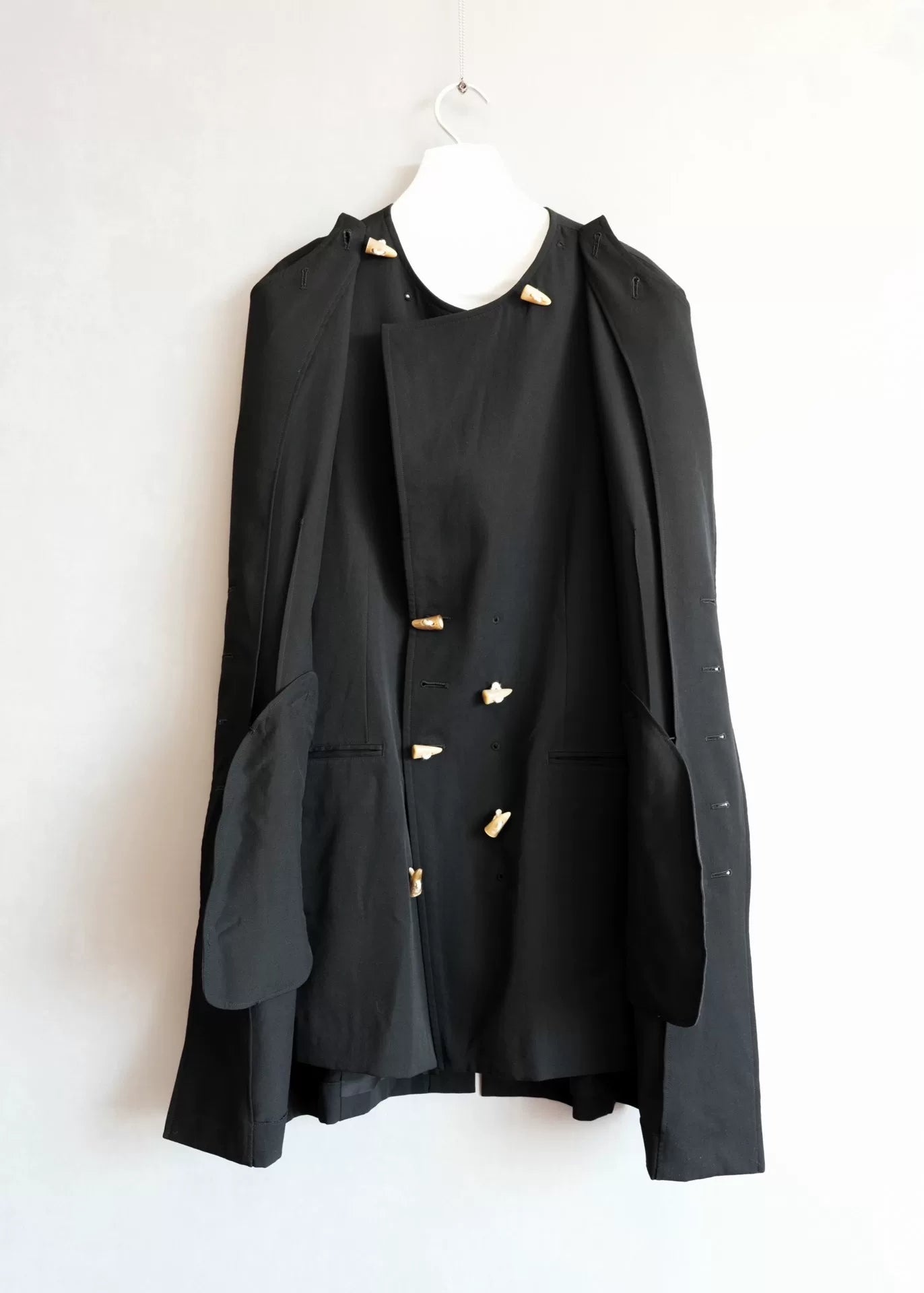 black double-breasted horn-button coat