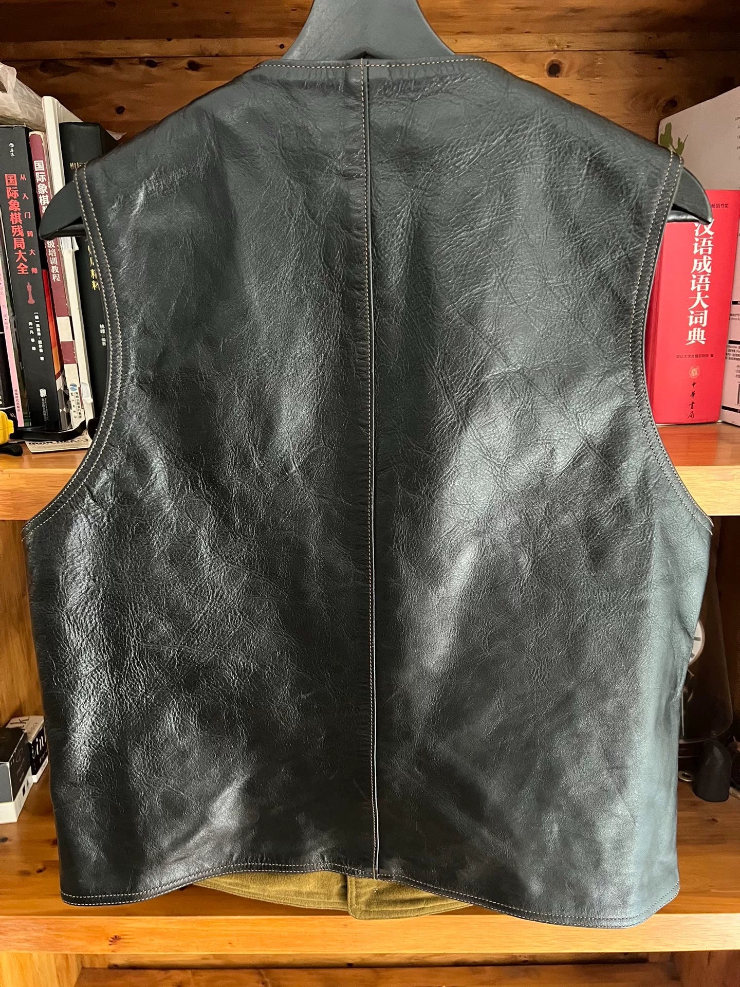 black leather vest with military green lining
