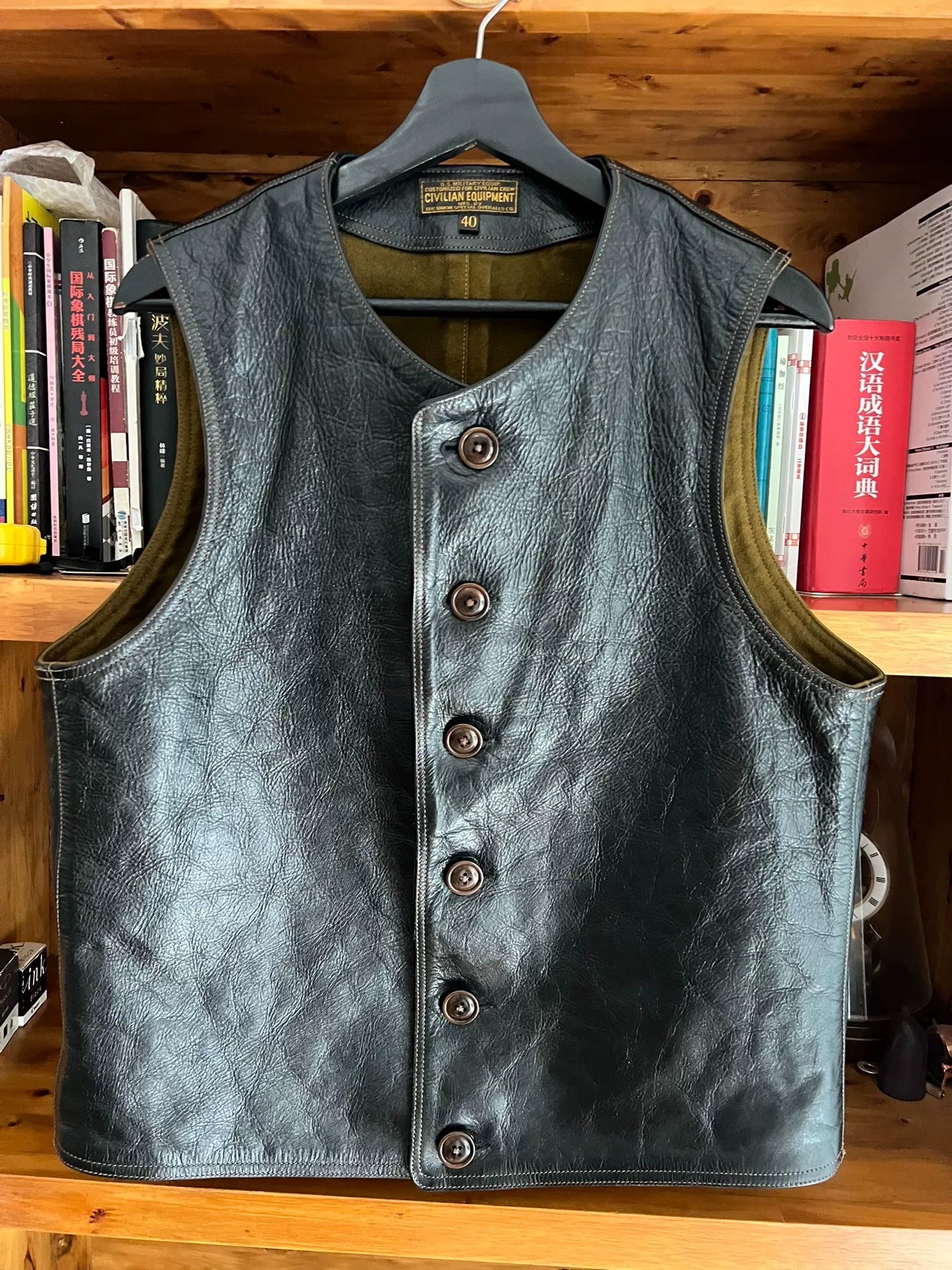 black leather vest with military green lining