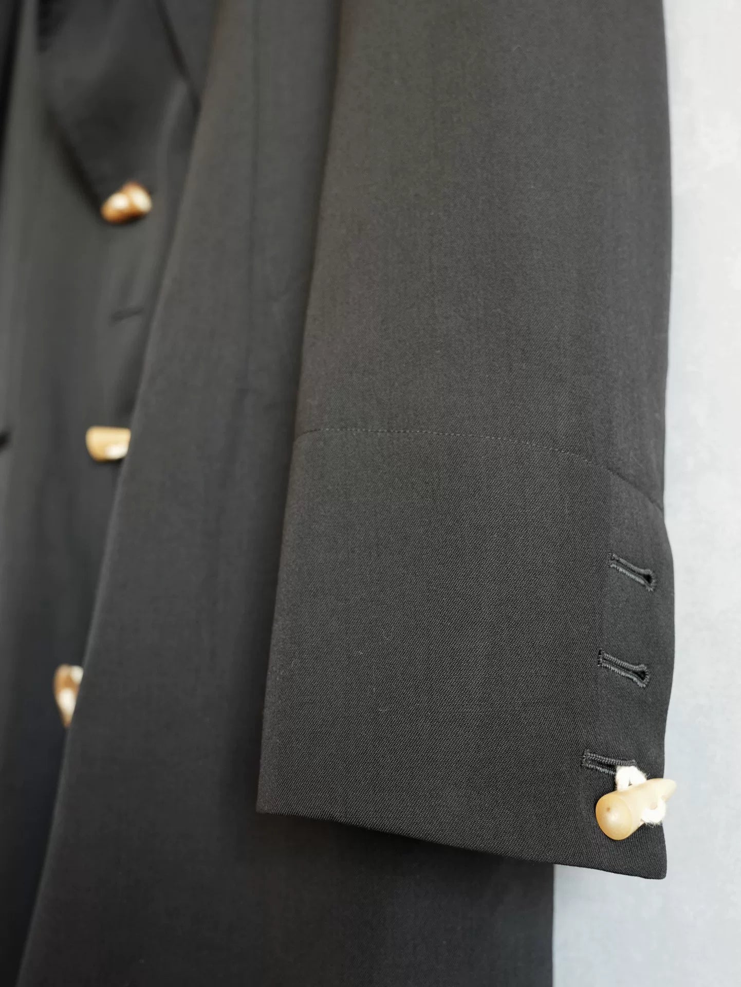 black double-breasted horn-button coat