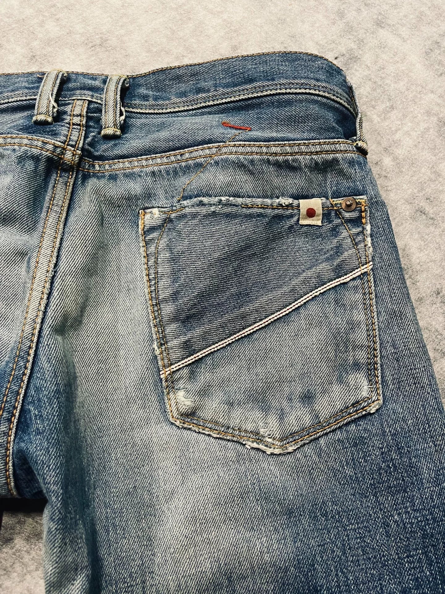 distressed low-rise blue denim jeans