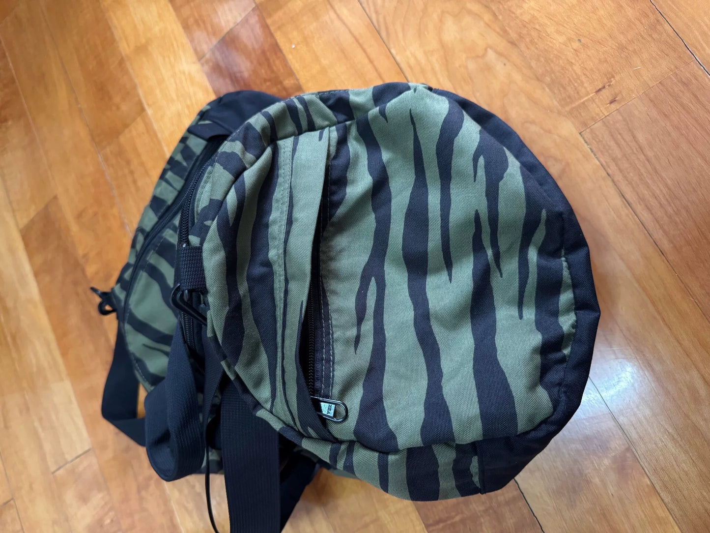 supreme camouflage duffle bag with red tag