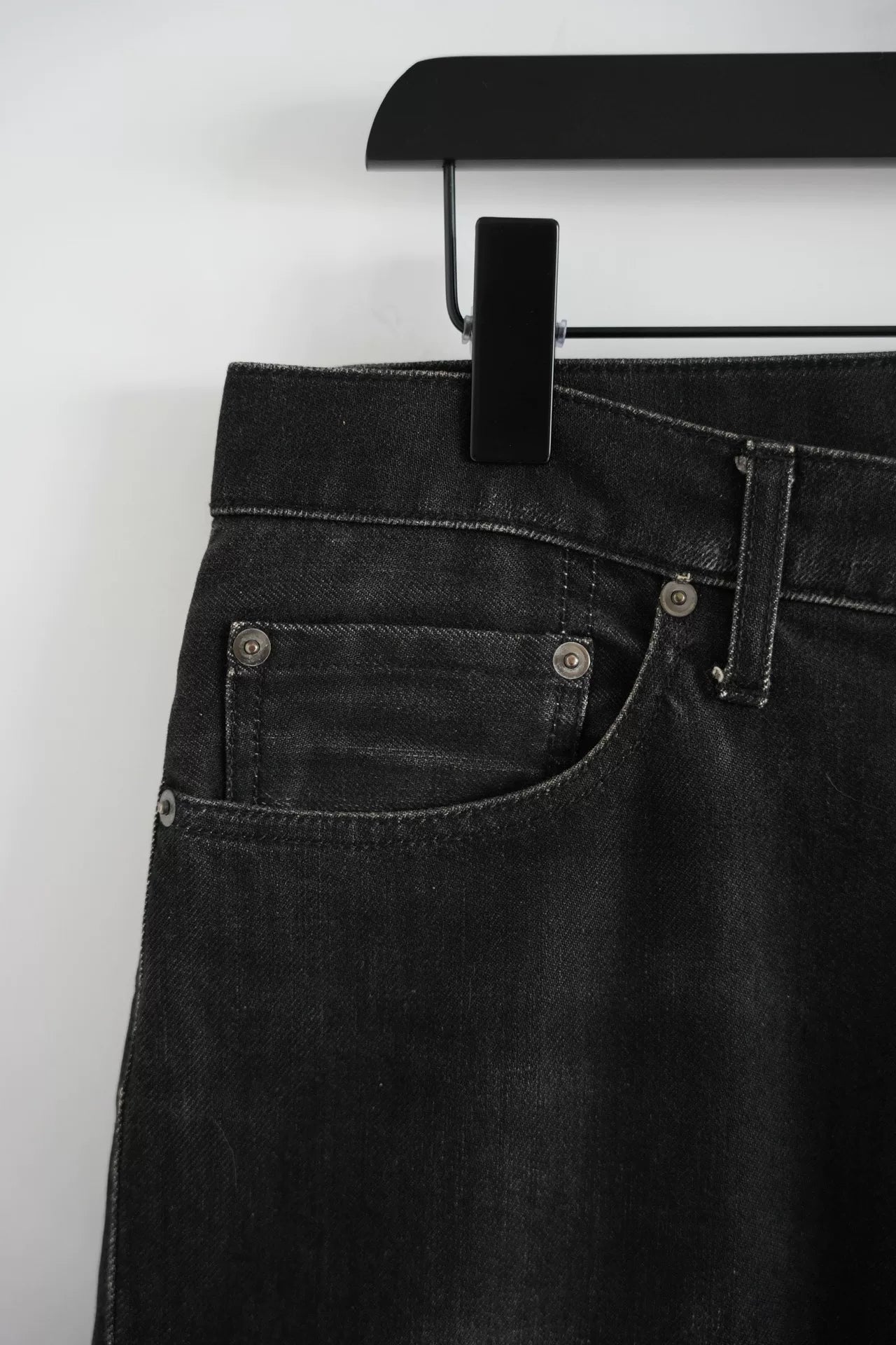 embroidered black denim pants by Undercover