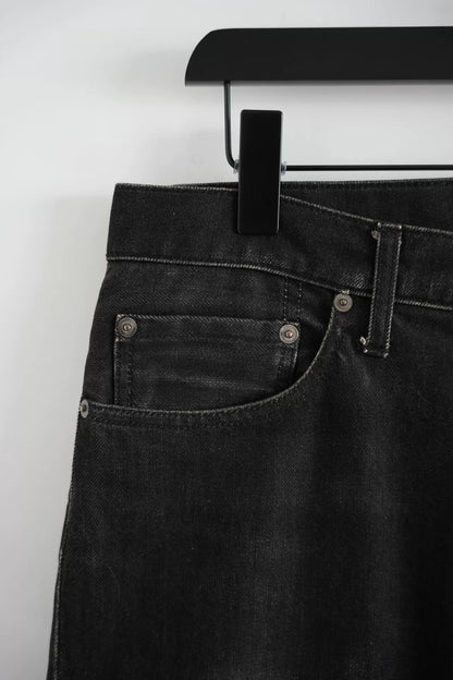 embroidered black denim pants by Undercover