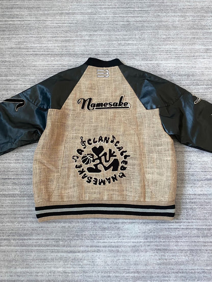 beige baseball jacket with leather sleeves