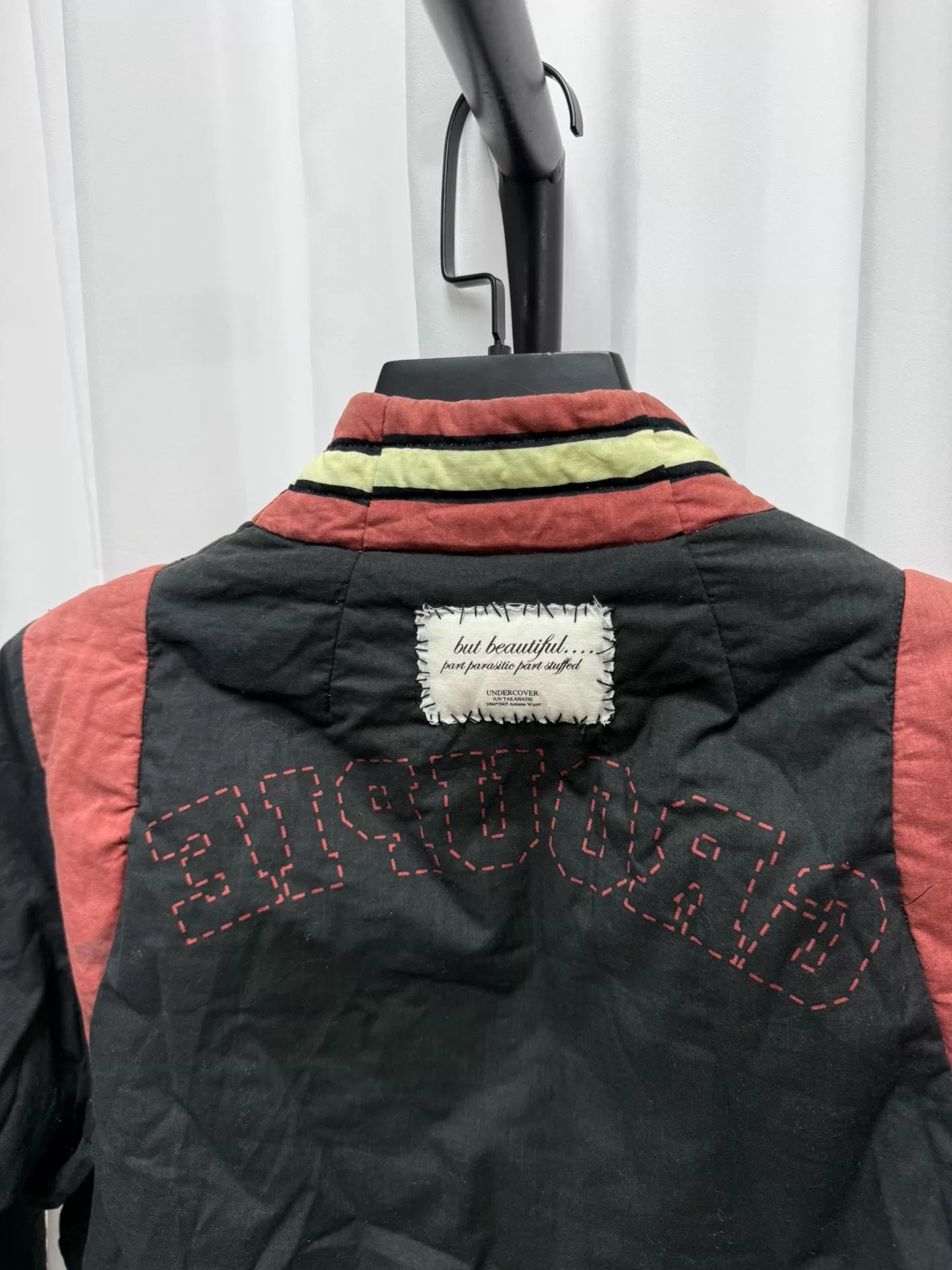 undercover bomber jacket with red accents
