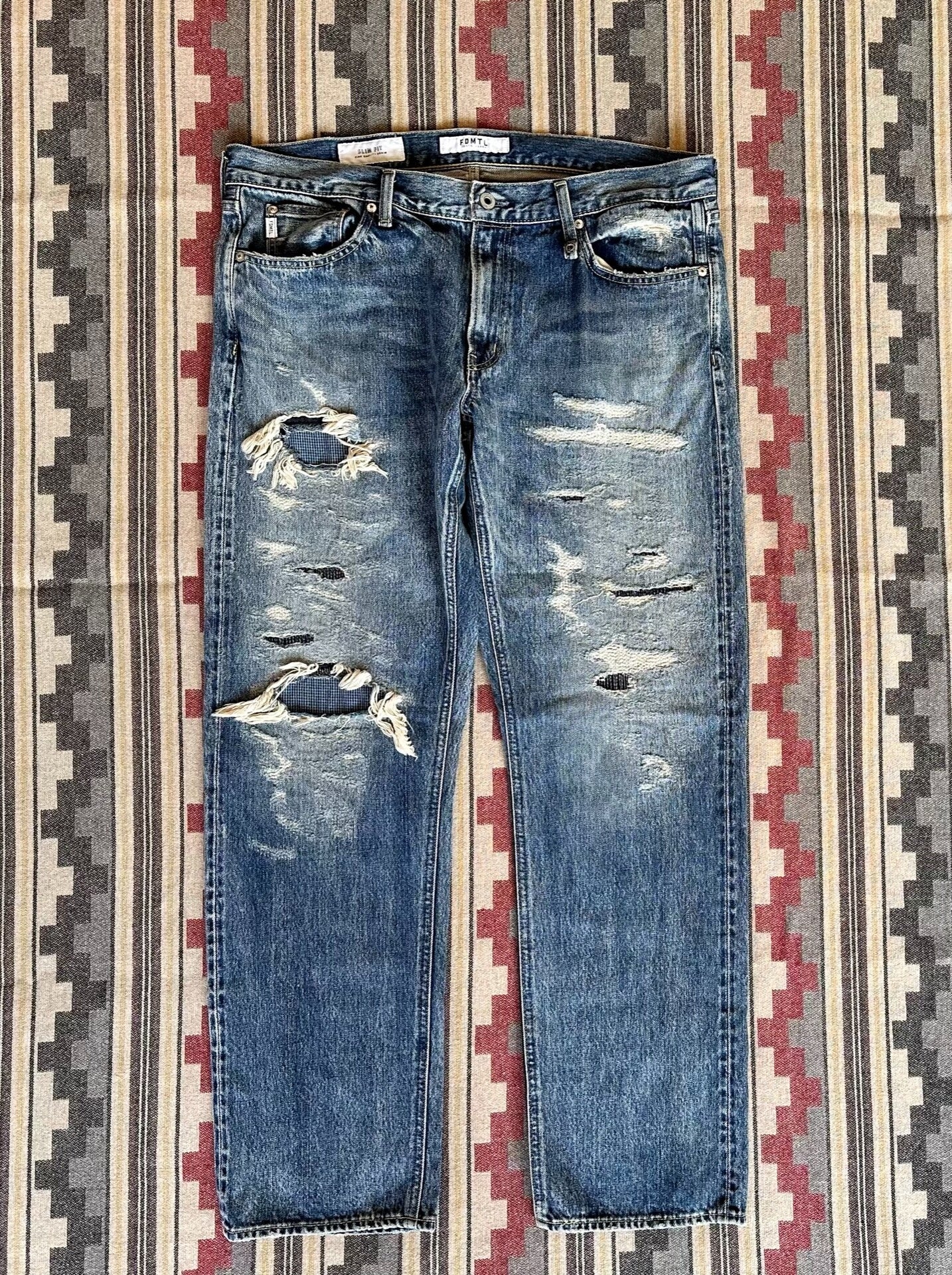 fdmtl slim fit distressed denim pants