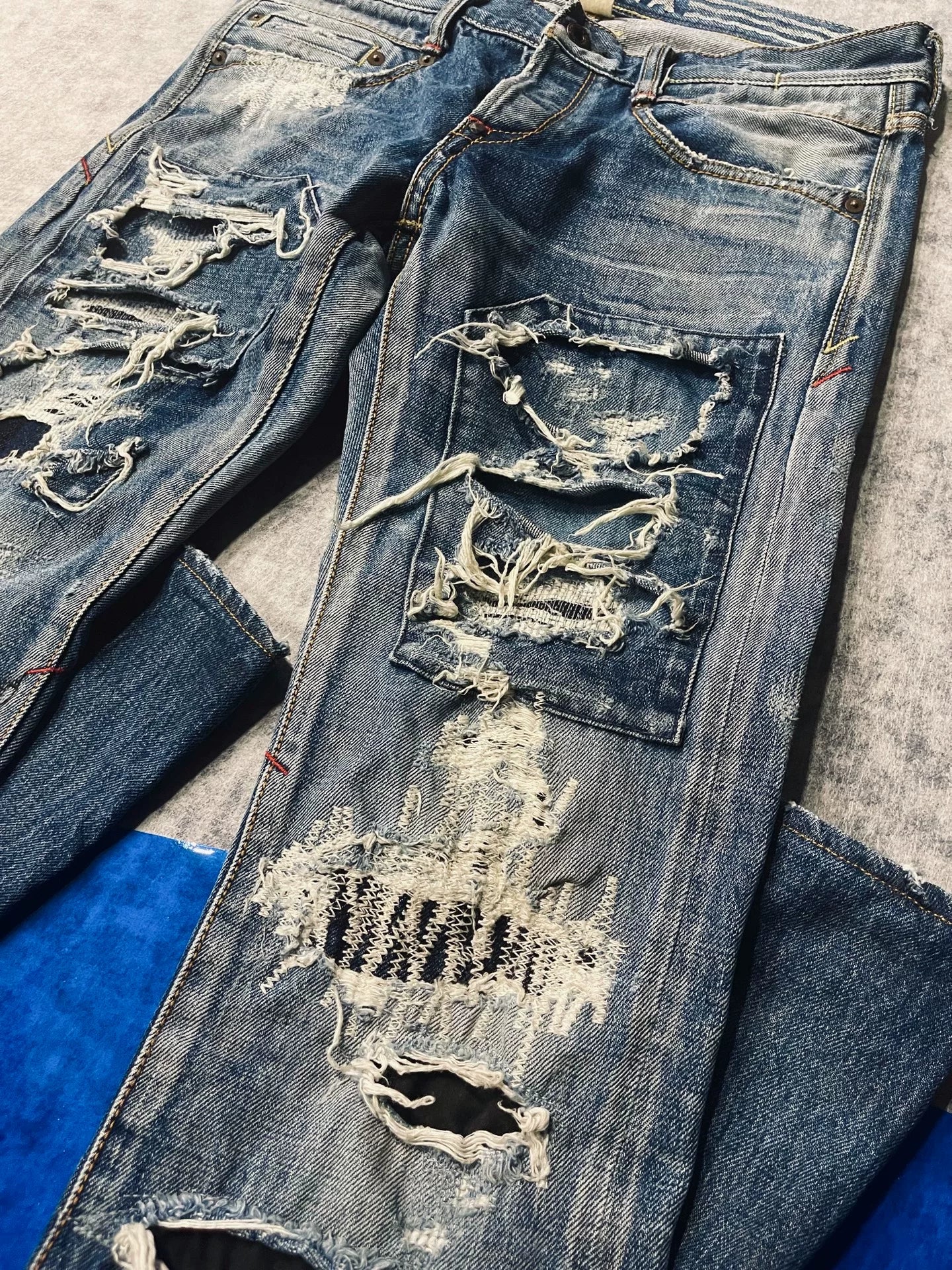 distressed low-rise blue denim jeans
