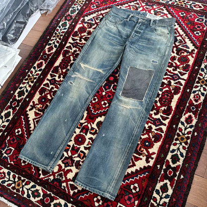 distressed blue jeans with unique detailing