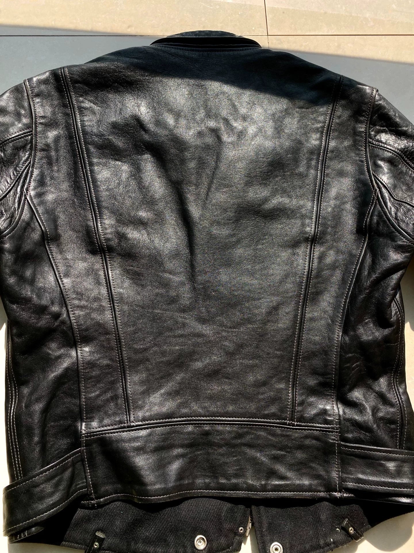 black leather biker jacket with detailed embellishments