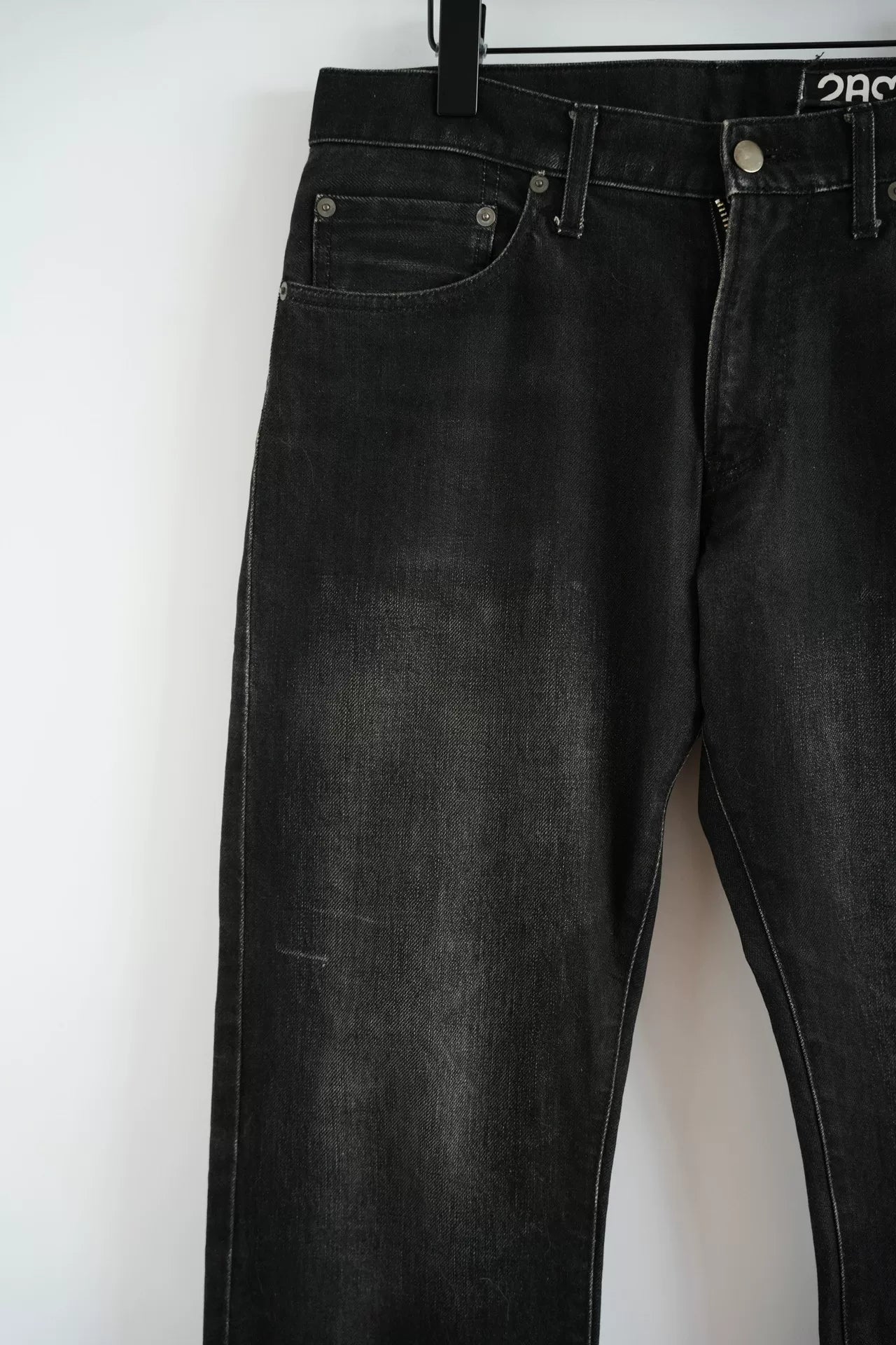 embroidered black denim pants by Undercover