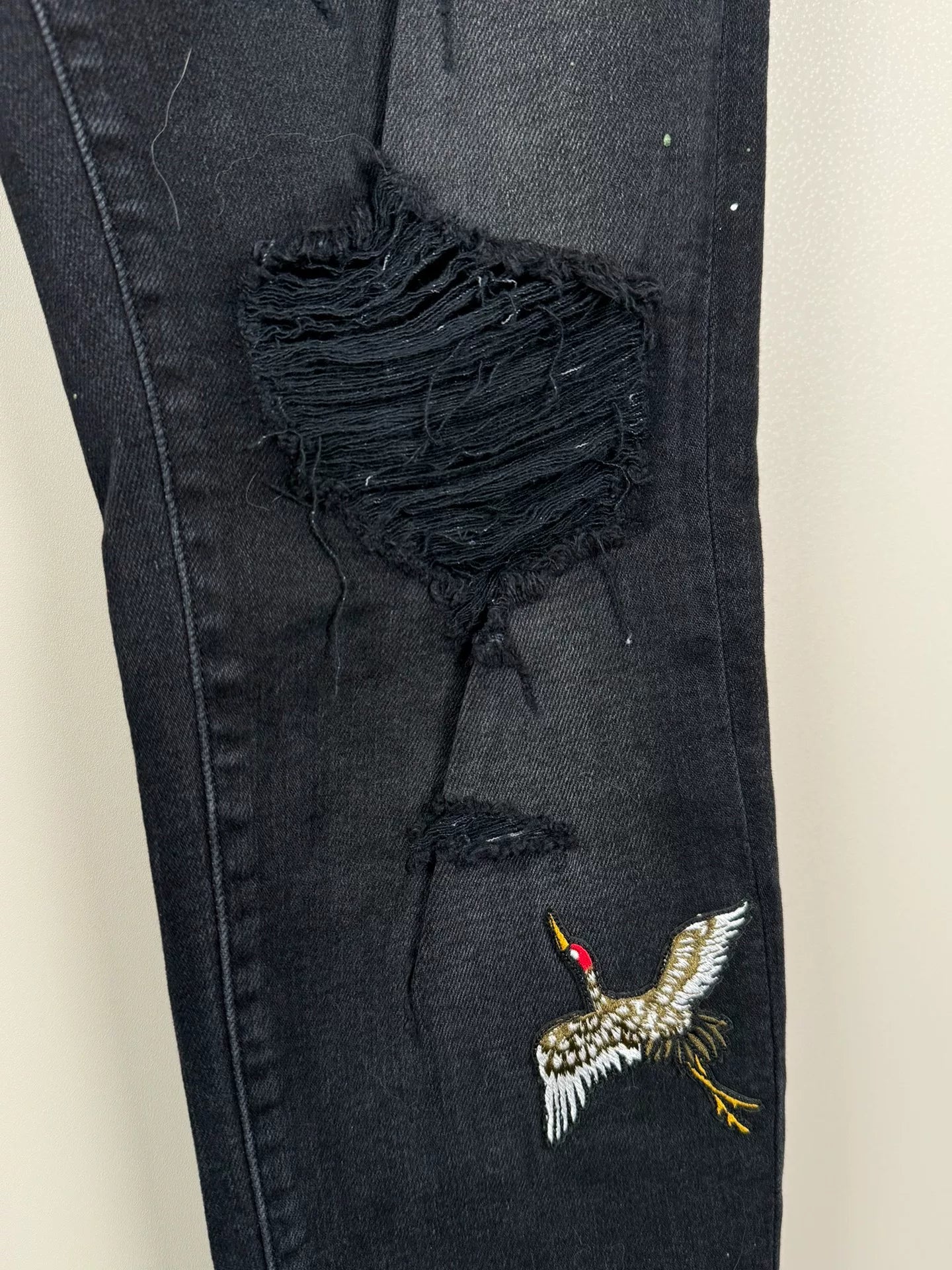 amiri crane graffiti embroidered distressed jeans
