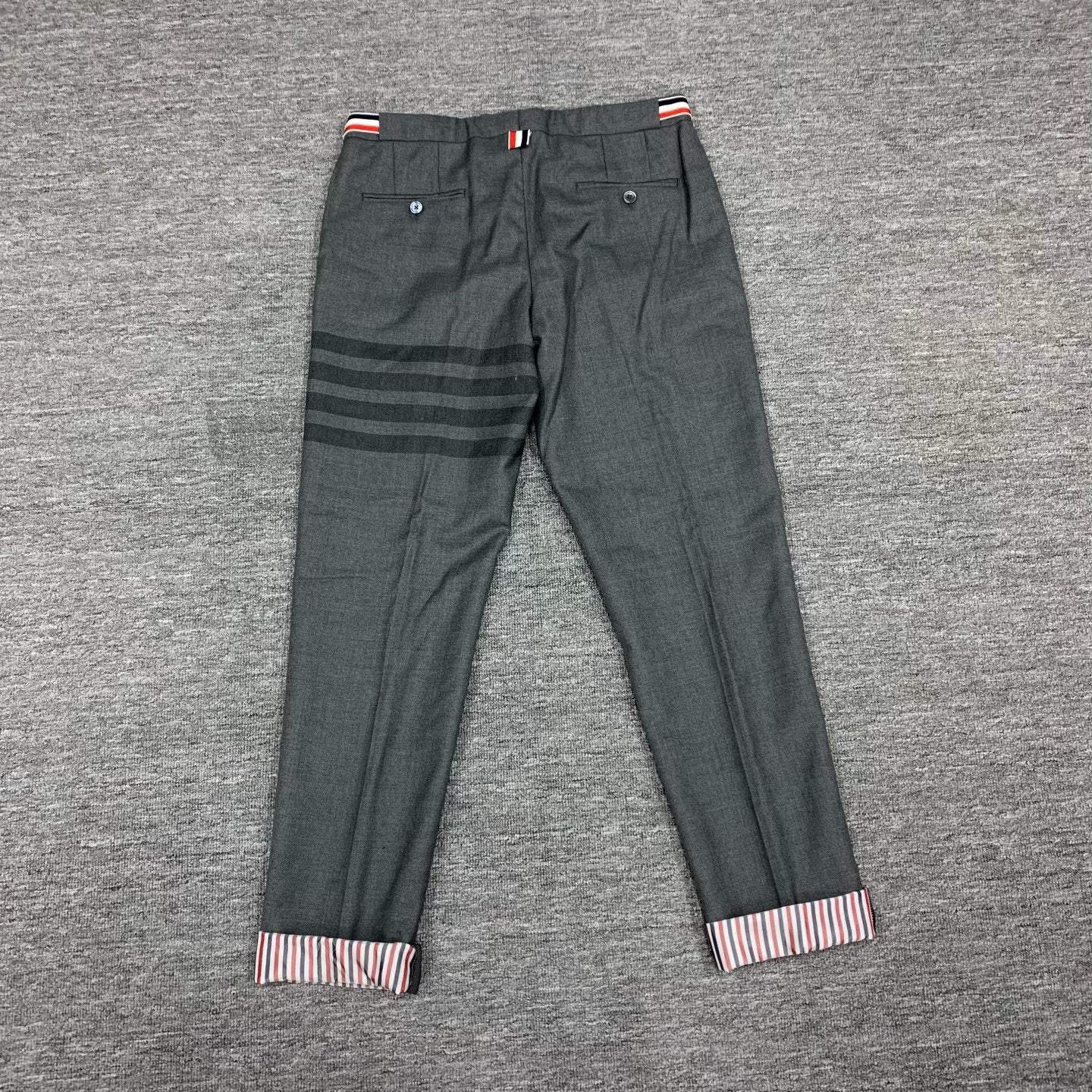 gray striped wool suit trousers by Thom Browne