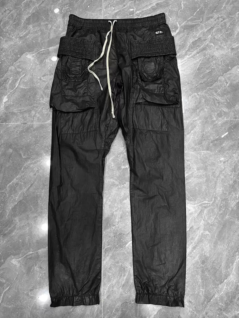 Rick Owens Wax glossy double-ring trousers with large pockets and drawstring.