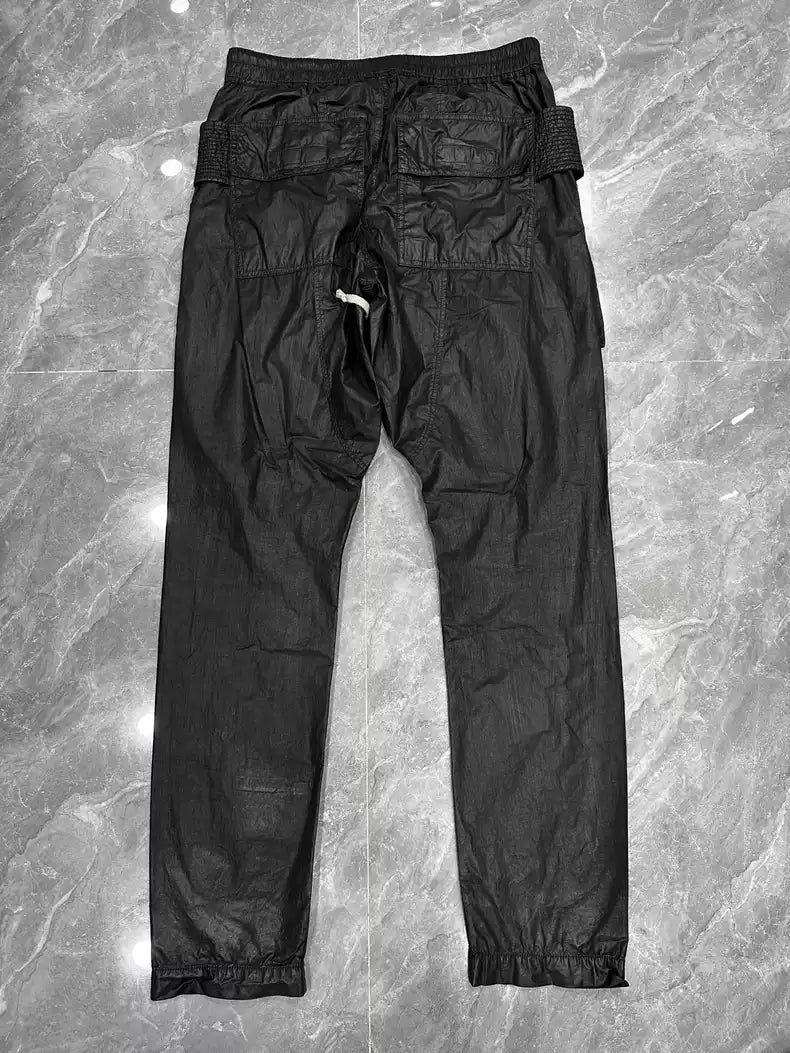 Rick Owens Wax glossy double-ring trousers with large pockets and drawstring.